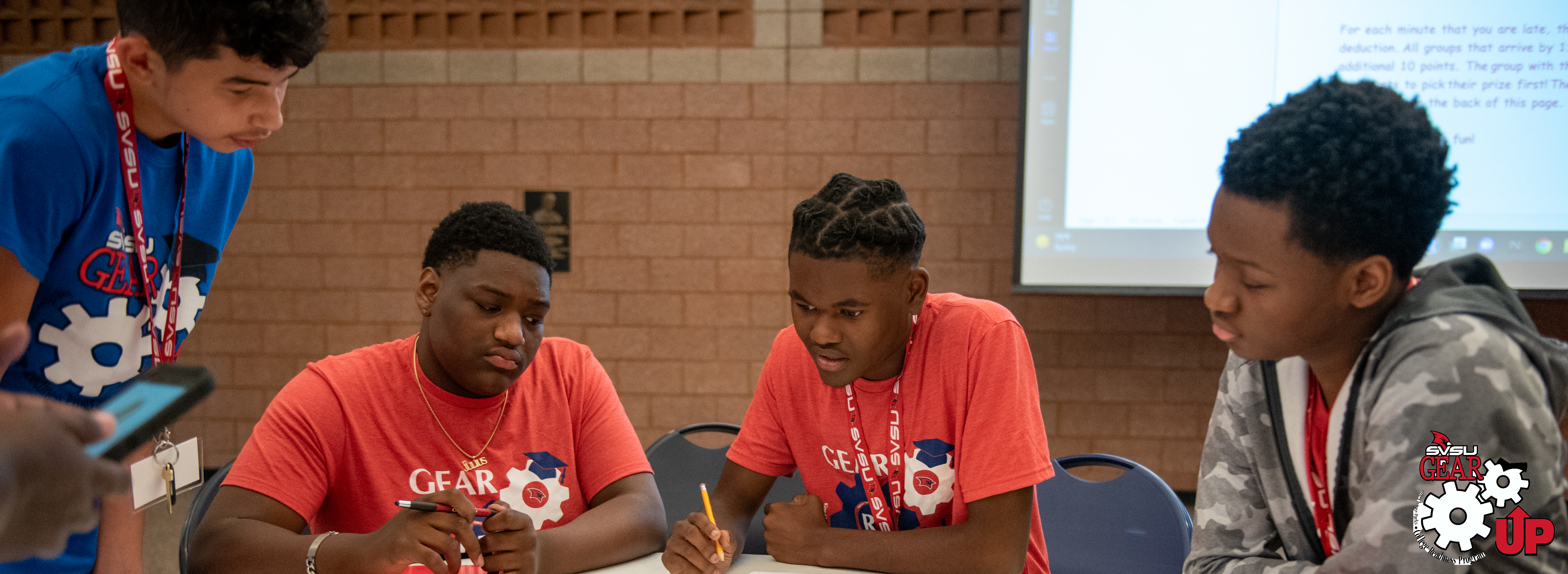 Gear Up students reviewing a project.